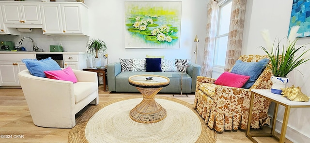 sitting room featuring sink and light hardwood / wood-style floors