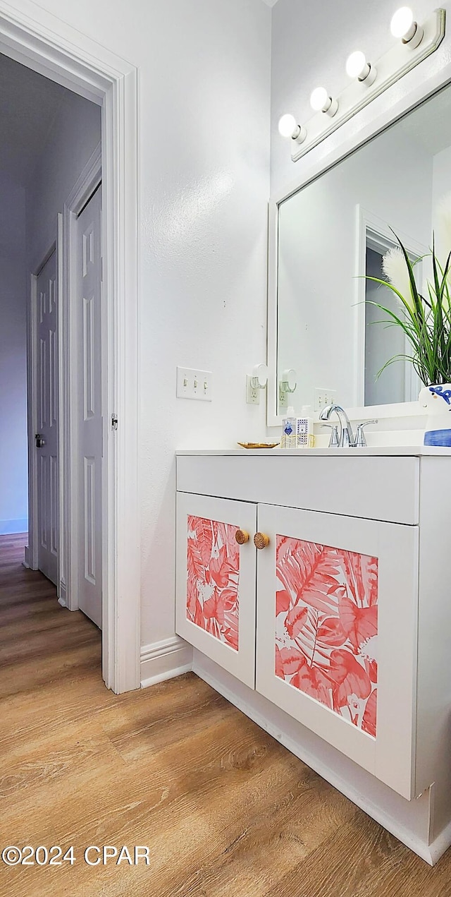 bathroom featuring wood-type flooring and vanity