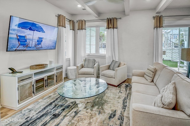 living room featuring beam ceiling and light hardwood / wood-style floors