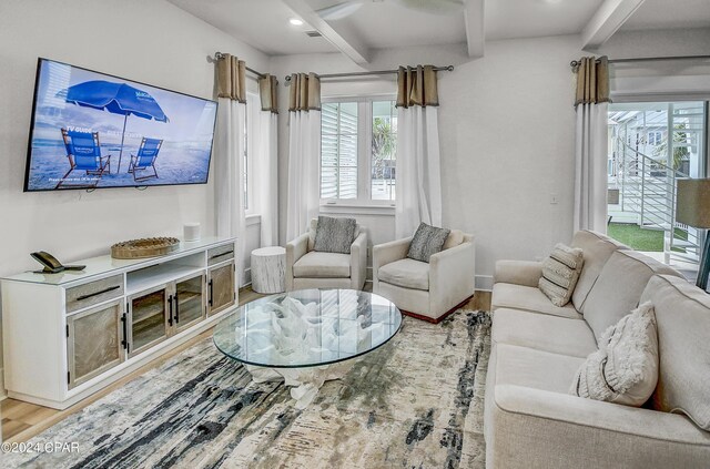 living room with beamed ceiling, ceiling fan, and light hardwood / wood-style floors