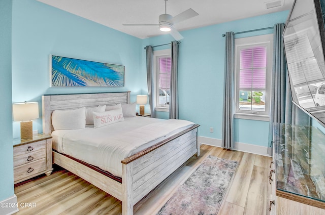 bedroom with light hardwood / wood-style flooring and ceiling fan