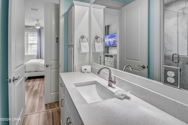 bathroom featuring ceiling fan, hardwood / wood-style flooring, and vanity