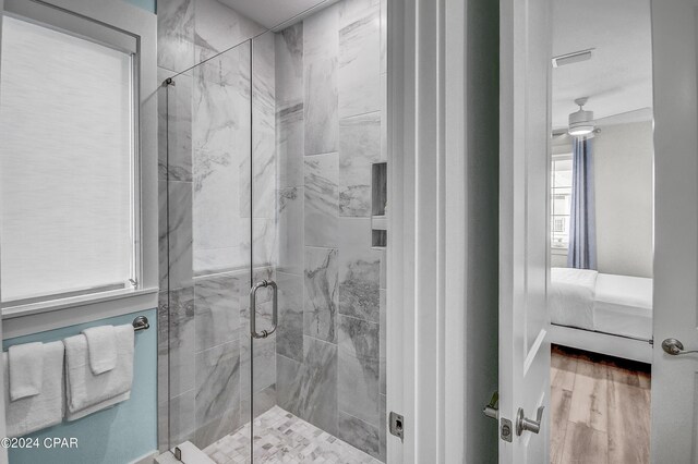 bathroom featuring walk in shower and hardwood / wood-style flooring