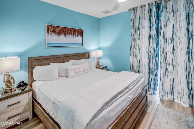 bedroom with ceiling fan and light hardwood / wood-style flooring