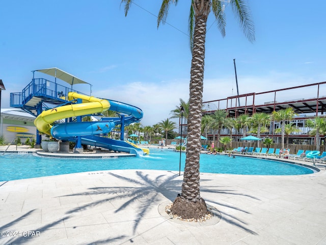 view of swimming pool featuring a patio and a water slide