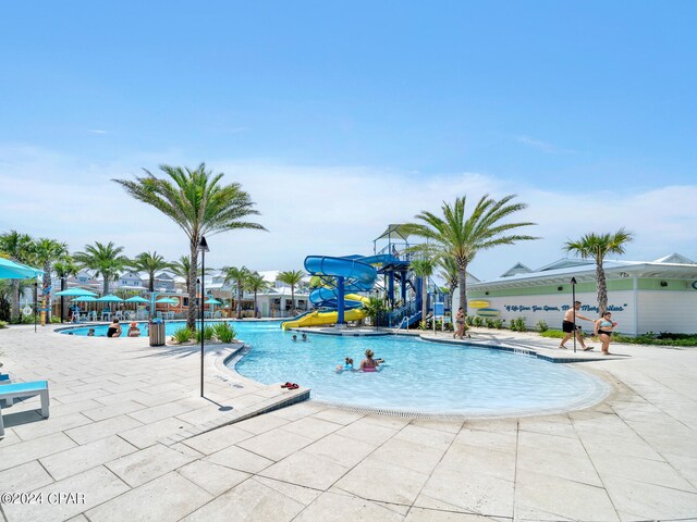 view of pool with a patio and a water slide