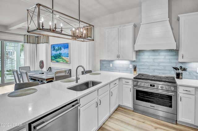 kitchen featuring backsplash, white cabinetry, custom range hood, and stainless steel gas range