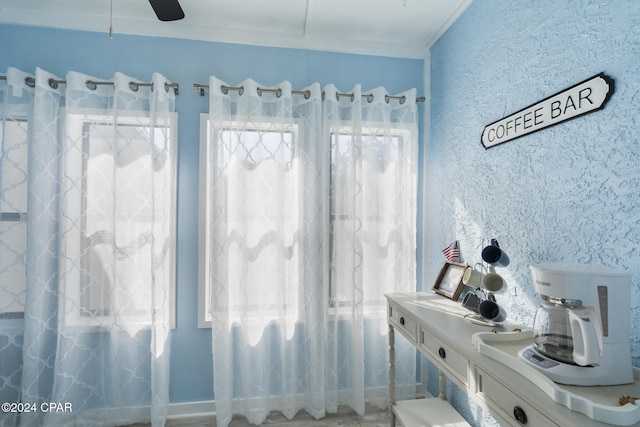 bathroom with ceiling fan and crown molding