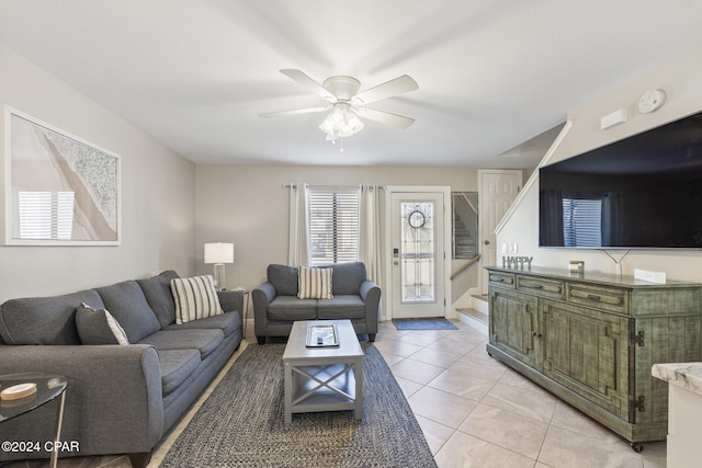 living room with ceiling fan and light tile patterned flooring