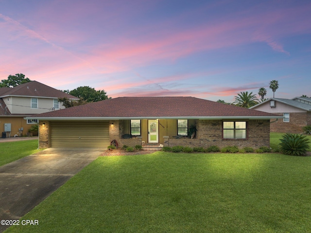 view of front of property featuring a yard and a garage