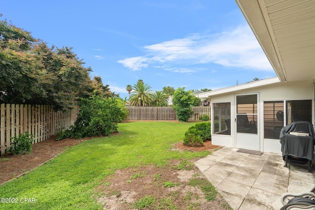 view of yard featuring a patio area and a sunroom