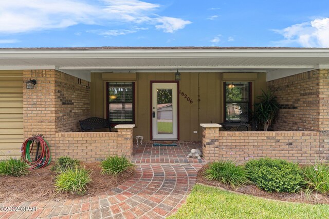 doorway to property featuring covered porch