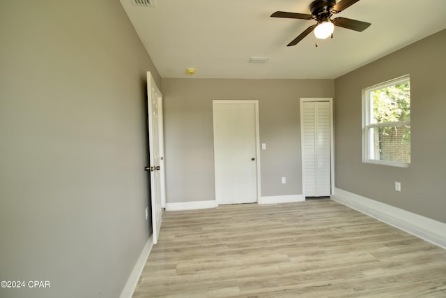 unfurnished bedroom featuring ceiling fan and light hardwood / wood-style floors