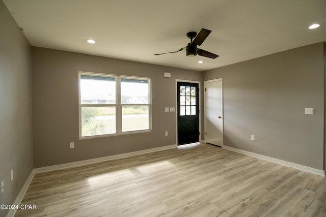 unfurnished room with ceiling fan and light wood-type flooring