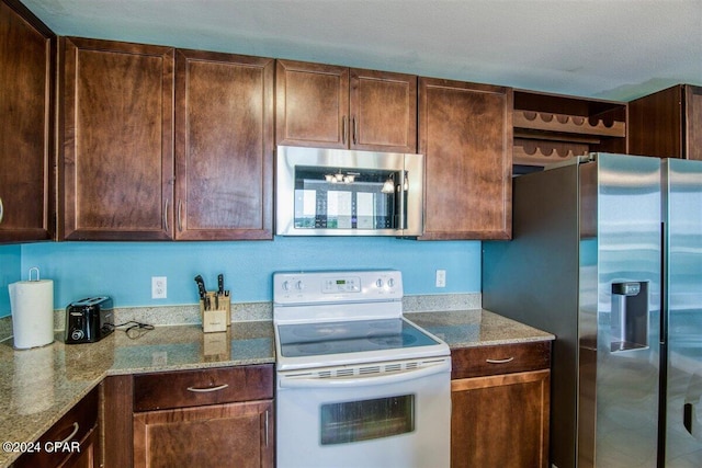 kitchen featuring stainless steel appliances and light stone countertops