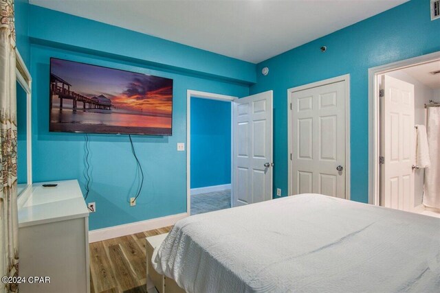 bedroom with wood-type flooring