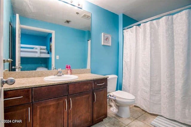 bathroom featuring toilet, tile patterned floors, and vanity