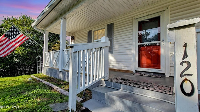 exterior entry at dusk with covered porch