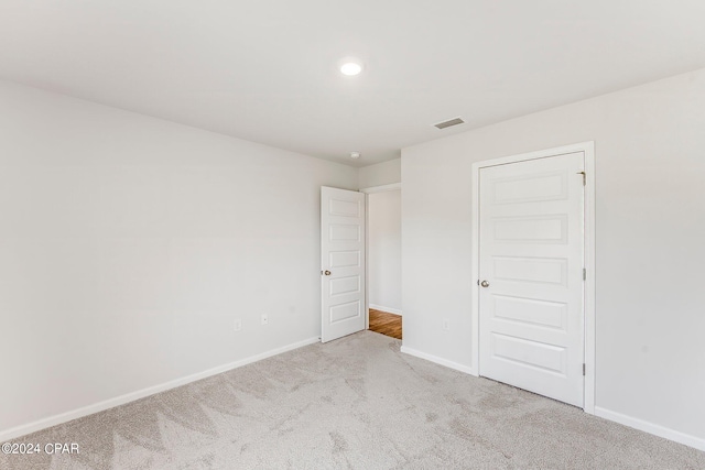 unfurnished bedroom with a closet and carpet flooring