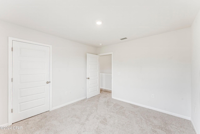 interior space featuring a closet and light colored carpet