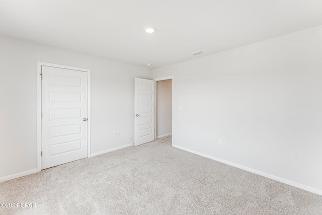 unfurnished bedroom with light colored carpet