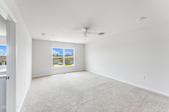 spare room featuring carpet floors and ceiling fan