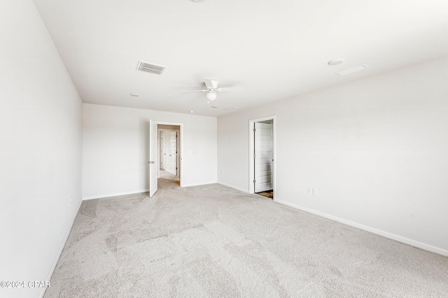 empty room featuring light colored carpet and ceiling fan