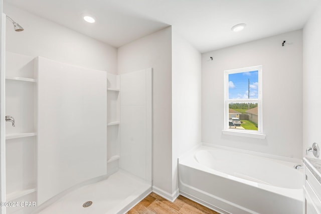 bathroom with vanity, separate shower and tub, and hardwood / wood-style flooring