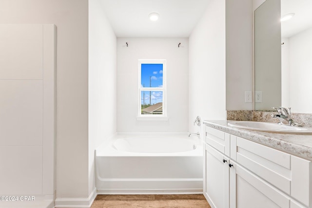 bathroom with vanity and a bathtub