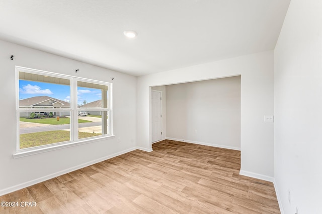 unfurnished room with light wood-type flooring