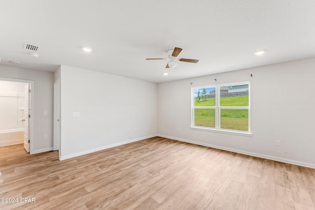 spare room featuring light hardwood / wood-style flooring and ceiling fan