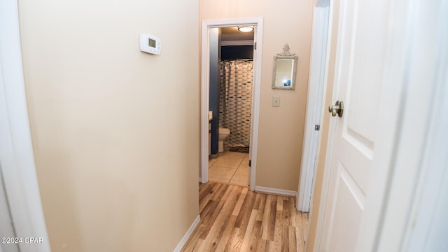 corridor with light hardwood / wood-style floors