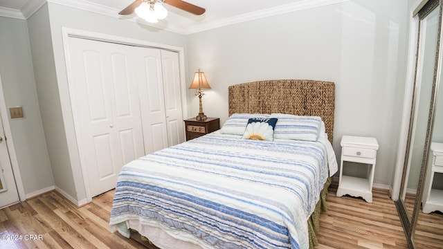 bedroom featuring a closet, ceiling fan, light wood-type flooring, and crown molding