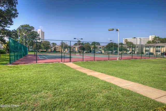 view of sport court featuring a yard