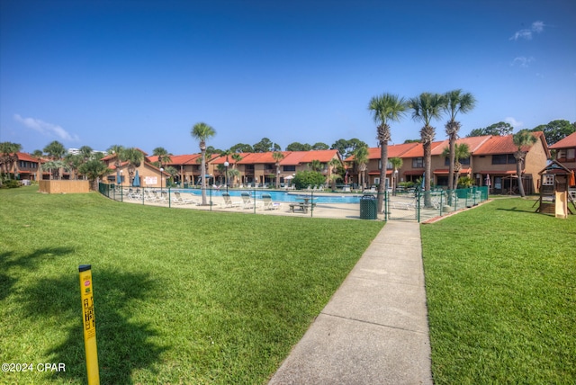 view of home's community with a yard and a swimming pool