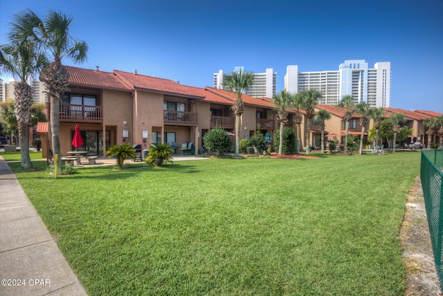 view of property's community with a lawn