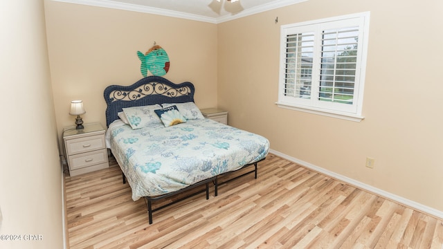 bedroom with ceiling fan, light wood-type flooring, and ornamental molding