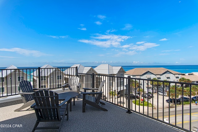 view of patio / terrace with a balcony and a water view