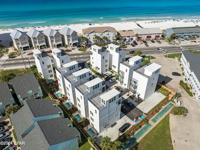 bird's eye view with a water view and a beach view