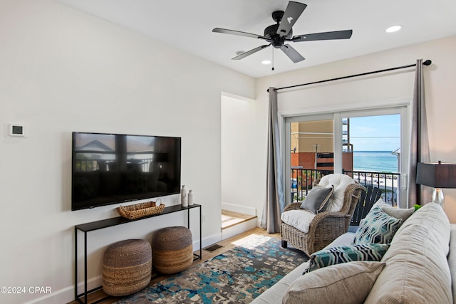 living room with light wood-type flooring and ceiling fan