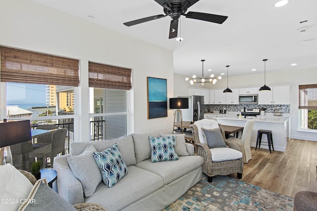 17674 Front Beach Rd Unit 10Units, Panama City Beach, FL 32413 - living area featuring recessed lighting, ceiling fan with notable chandelier, and light wood finished floors