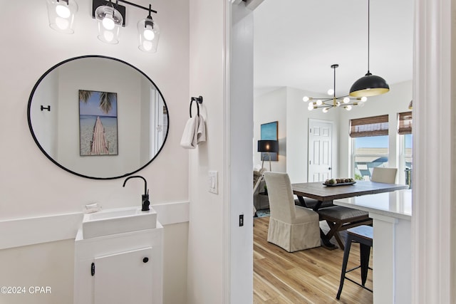 17674 Front Beach Rd Unit 10Units, Panama City Beach, FL 32413 - bathroom with vanity, wood finished floors, and a notable chandelier