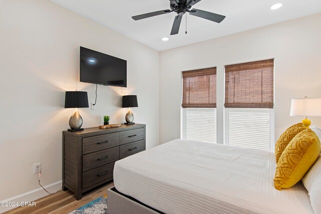 bedroom with ceiling fan and light hardwood / wood-style flooring