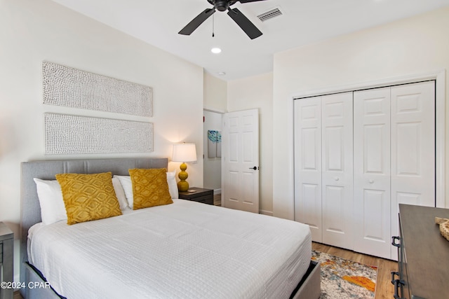 bedroom featuring light hardwood / wood-style flooring, a closet, and ceiling fan