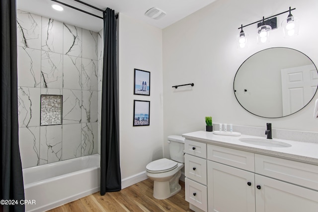 full bathroom featuring vanity, shower / tub combo, wood-type flooring, and toilet