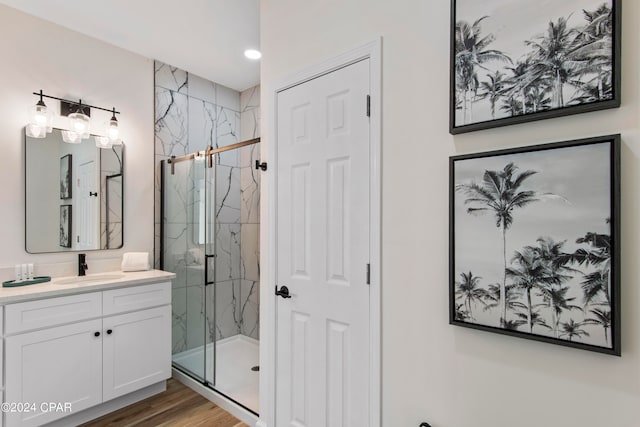 bathroom with vanity, wood-type flooring, and walk in shower