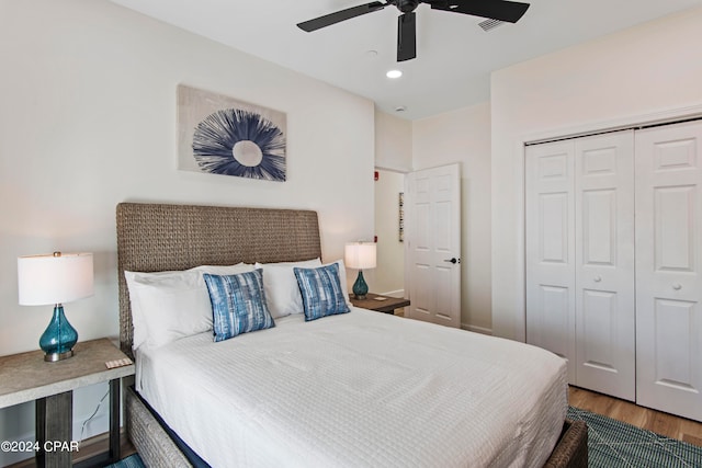 bedroom featuring hardwood / wood-style flooring, a closet, and ceiling fan