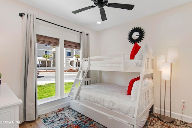 bedroom with ceiling fan and light wood-type flooring