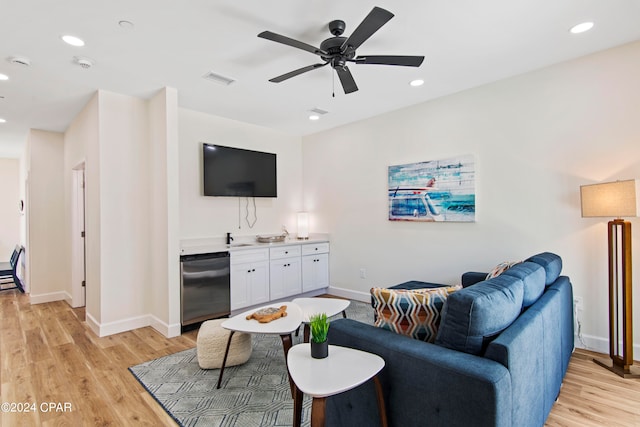 living room with ceiling fan and light hardwood / wood-style floors