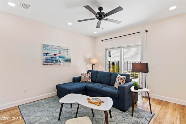 living room with light hardwood / wood-style floors and ceiling fan